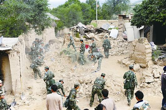 解放軍正站在幫助災民清理廢墟